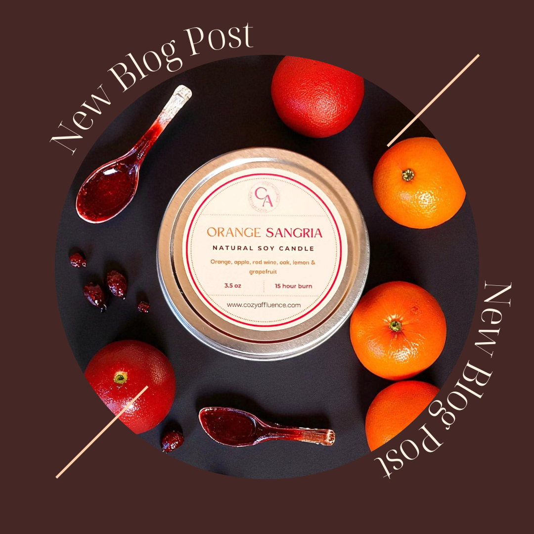 Blog post photo with orange sangria candle in a tin with spoons and fresh oranges