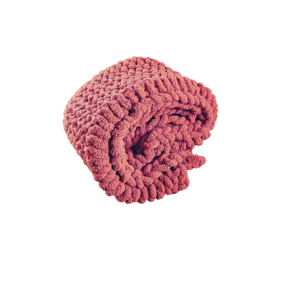 Folded burnt orange blanket.