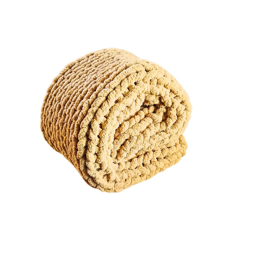 Folded mustard yellow chunky knit blanket.