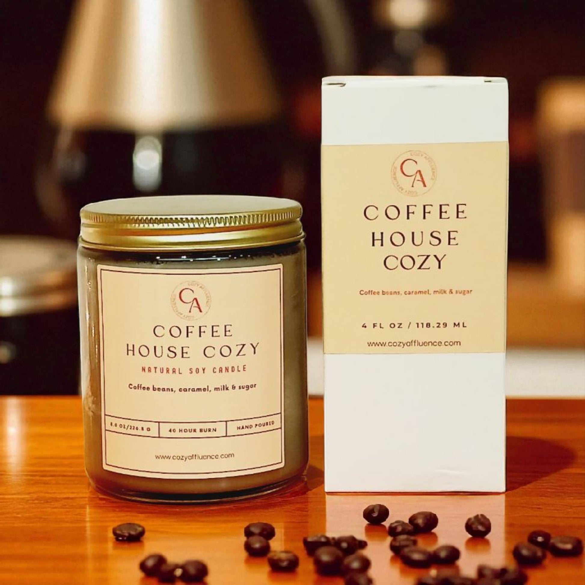 Coffee House Cozy candle and packaging on a wooden surface with coffee beans.