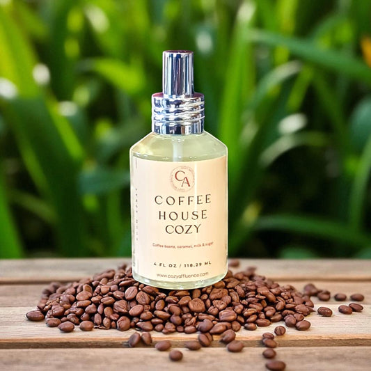 Bottle of 'Coffee House Cozy' on a wooden surface with coffee beans