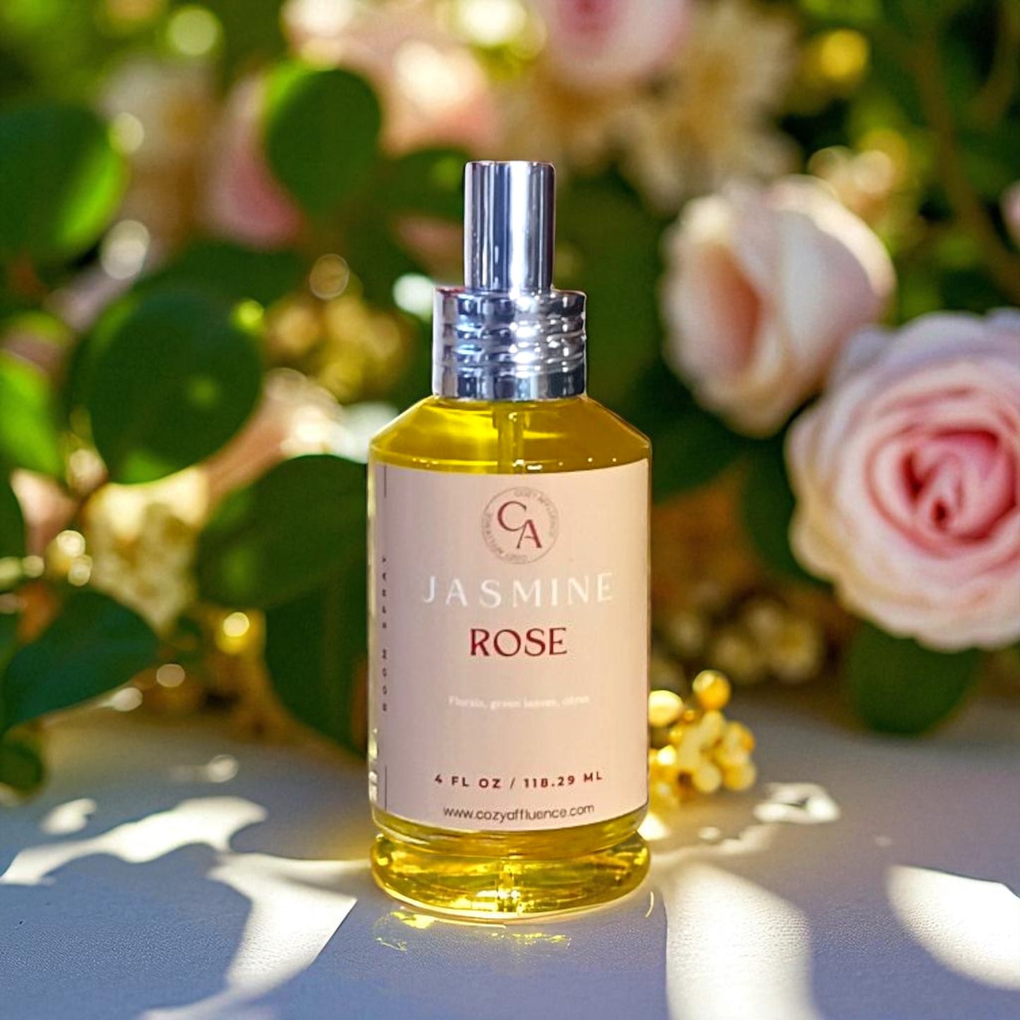 Bottle of Jasmine Rose room spray with a floral background.