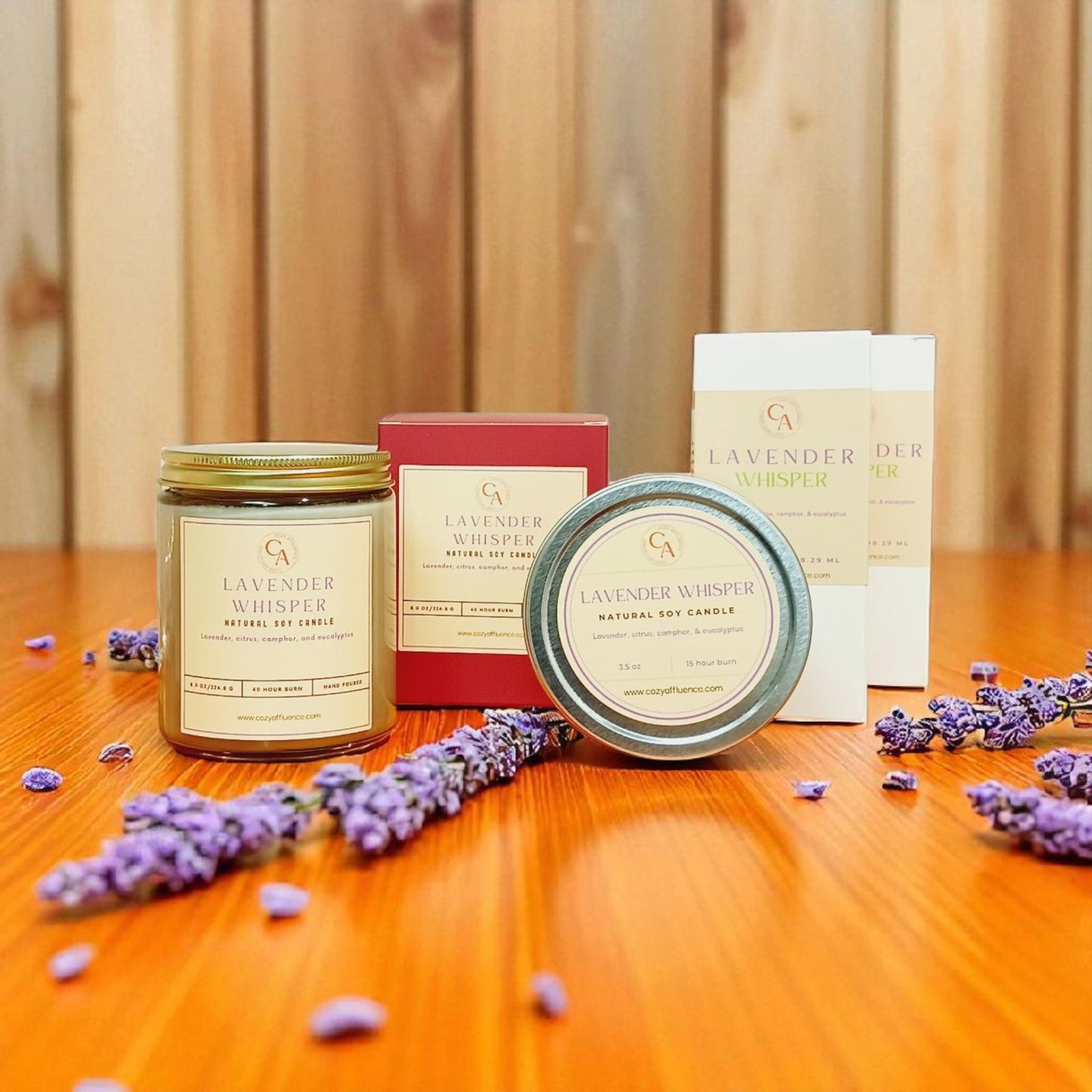 Candles and packaging with lavender on a wooden surface