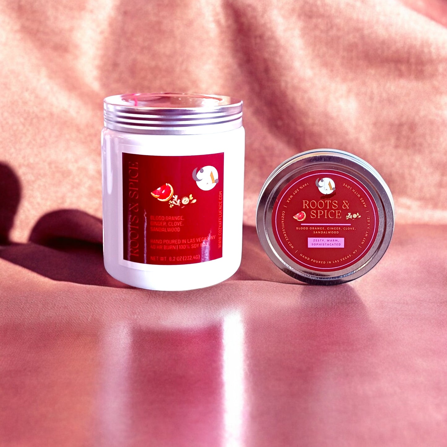 Roots & Spice 8oz & 3.5oz candle and tin combo on a soft red background.