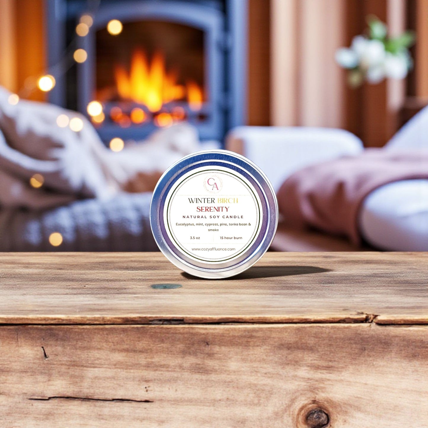 Candle labeled 'Winter Serenity' on a wooden surface with a fireplace in the background